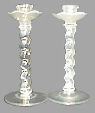 Called #45 JACOBEAN Style in old catalogs, these White stretch candlesticks are 9.5 in. tallx4.25 in. base - made by U.S. Glass. One received more iridization than the other