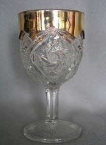 Double Pinwheel or Whirling Star wine with gold trim.